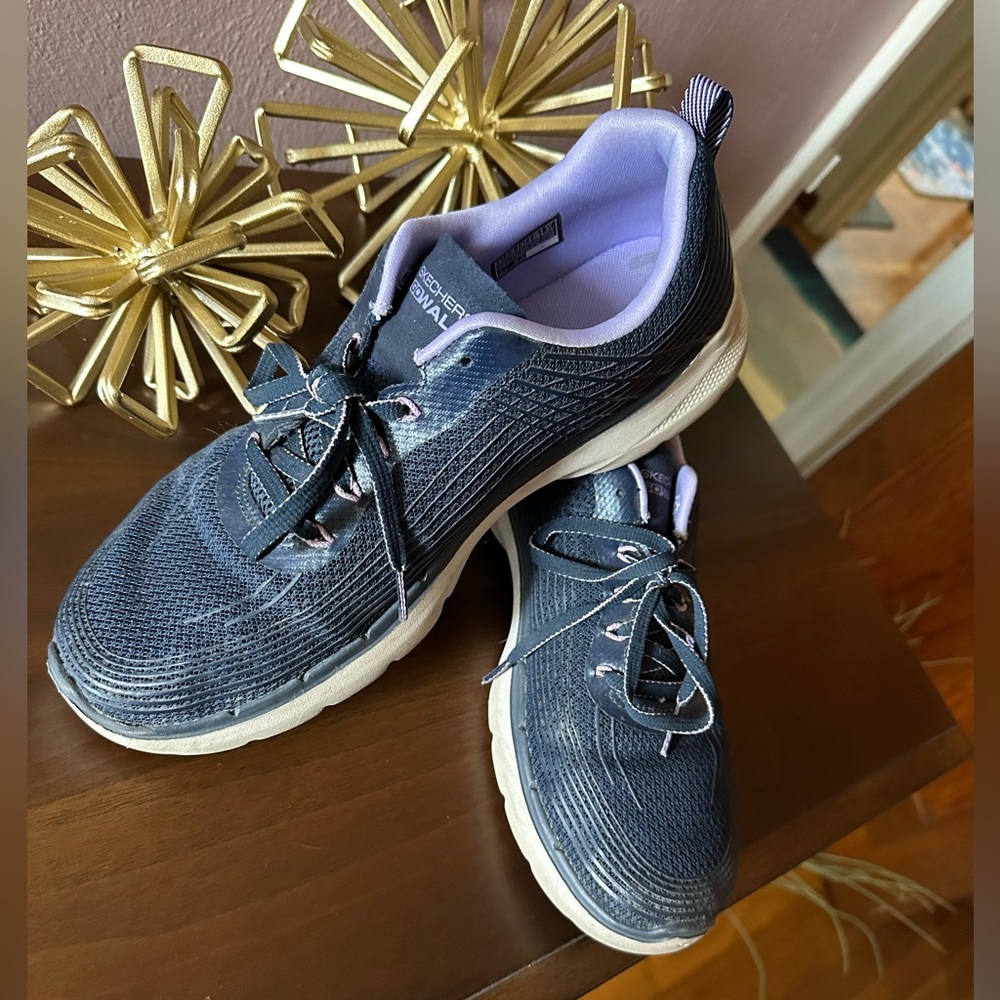 Lightly used Skechers. Navy with lilac accent.
